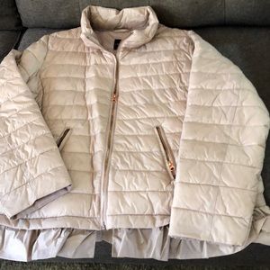 Light pale mauve puffer with rose gold zippers with ruffle about the bottom.